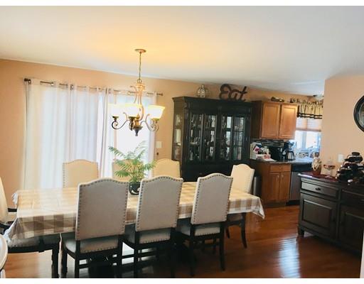 217 Reeves Street Fall River, MA 02721 - Photo 4 of 12 a dining room with furniture a chandelier and wooden floor
