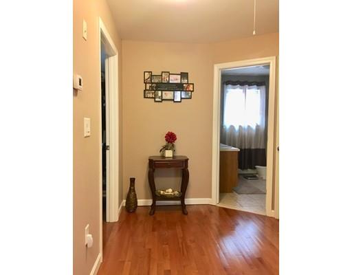 217 Reeves Street Fall River, MA 02721 - Photo 5 of 12 a workspace with wooden floor and a bathroom