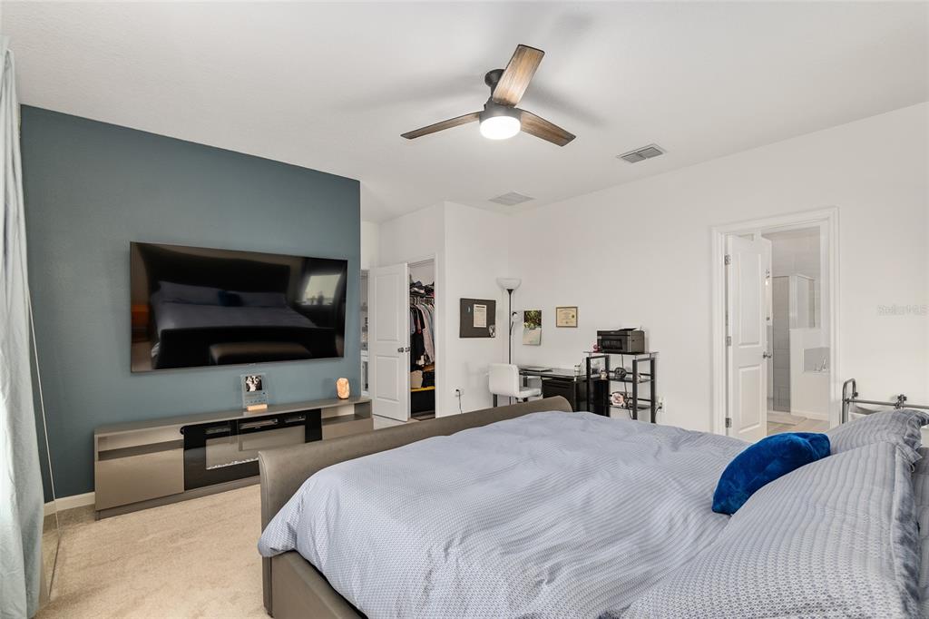 5688 Southwest 92nd Place Ocala, FL 34476 - Photo 27 of 54 a bedroom with a bed and a flat screen tv