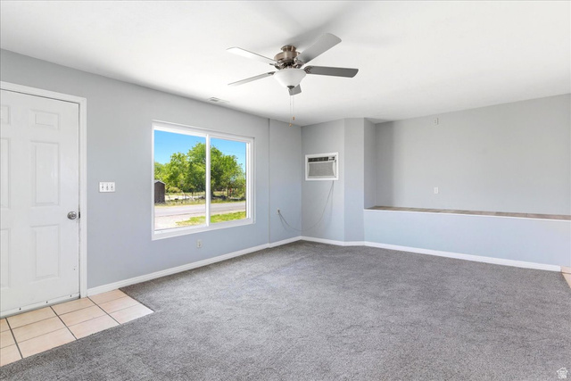 1613 Sunset Road Lake Point, UT 84074 - Photo 4 of 33 Spacious interior with neutral gray walls and gray carpet flooring