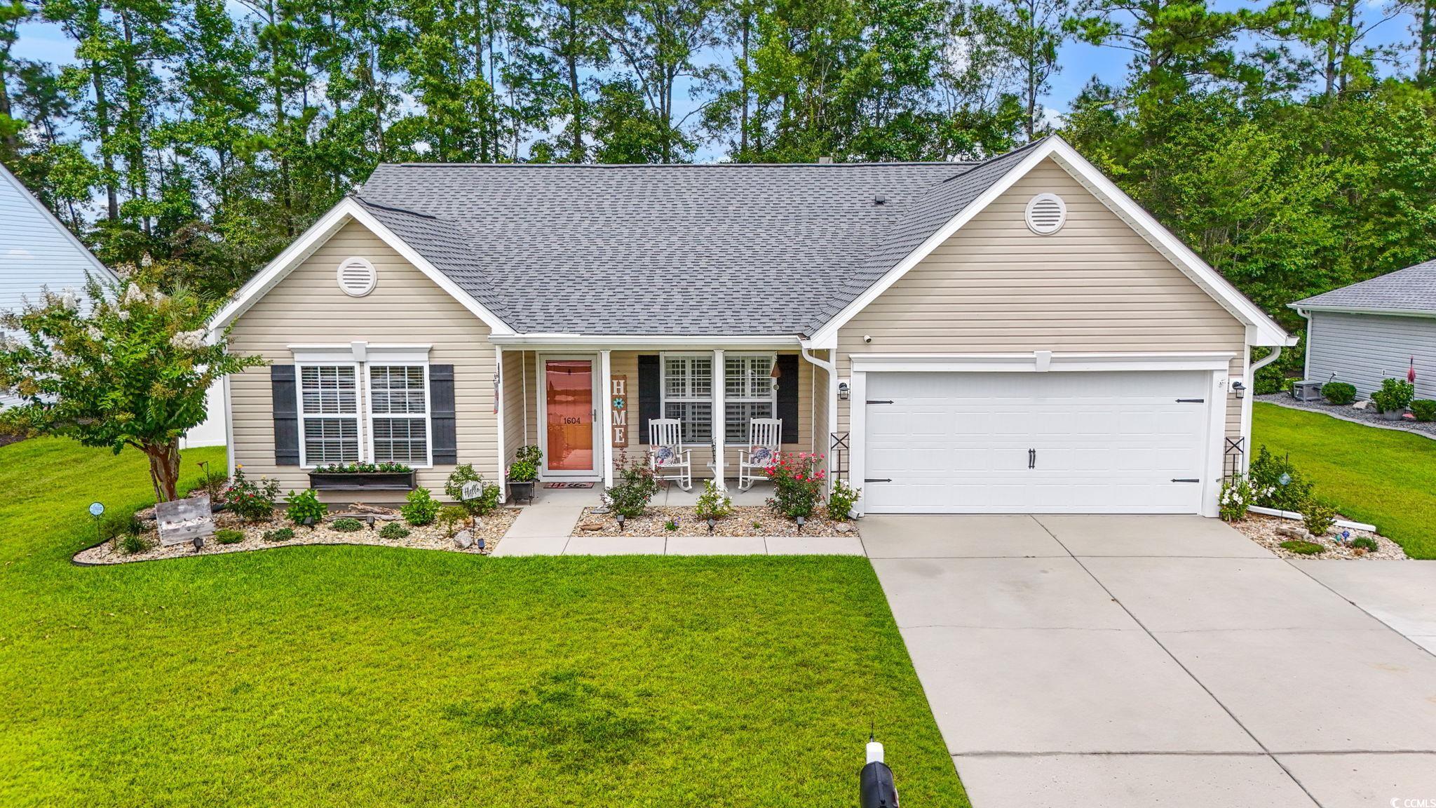 1604 Langley Drive Longs, SC 29568 - Photo 1 of 37 Single story home with a front yard, roof with shingles, driveway, covered porch, and an attached garage