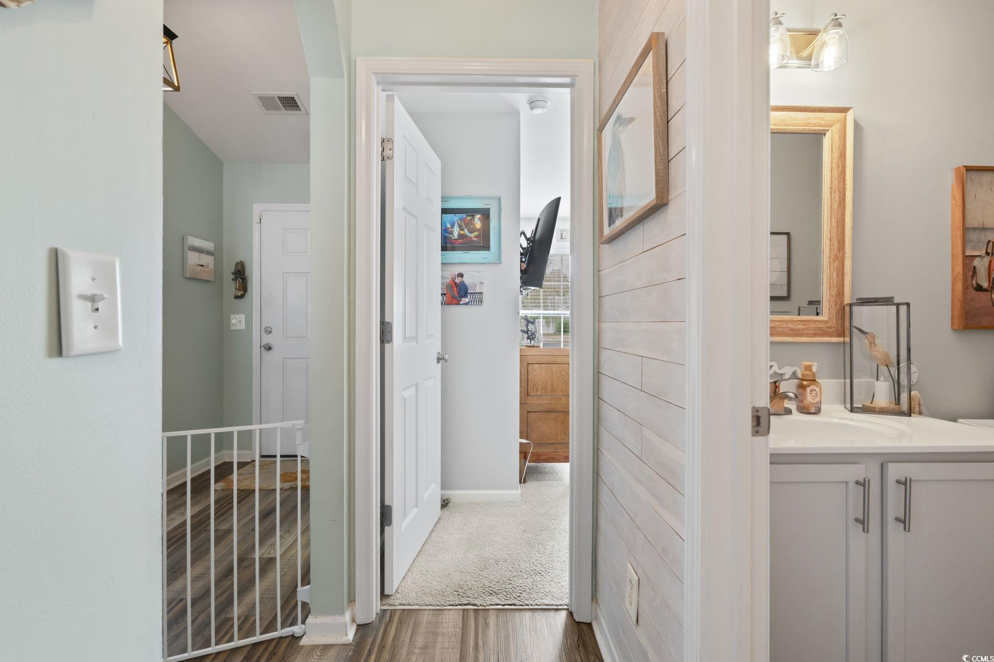 1604 Langley Drive Longs, SC 29568 - Photo 13 of 37 Hallway featuring dark wood-style floors and baseboards