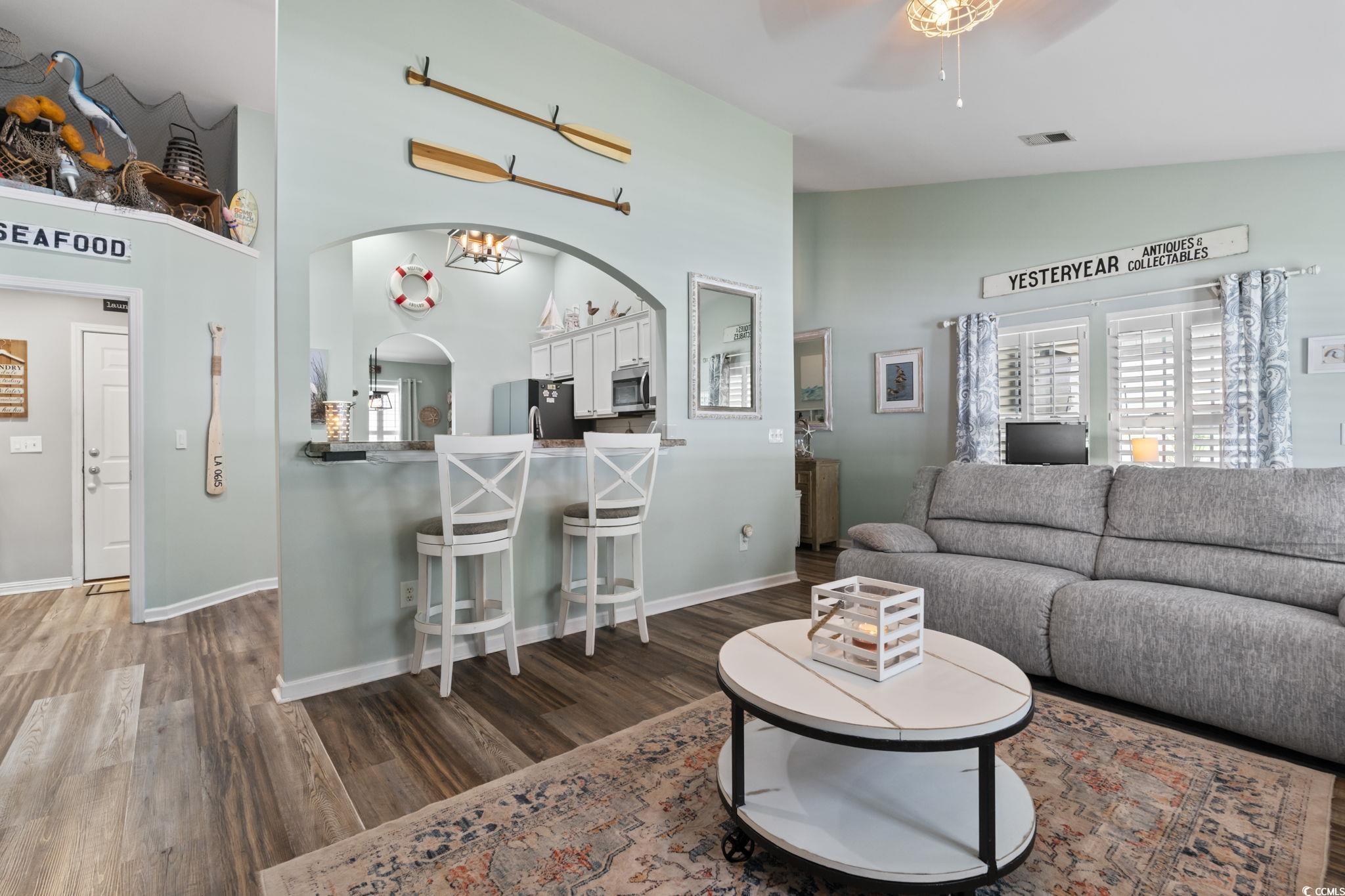1604 Langley Drive Longs, SC 29568 - Photo 18 of 37 Living room with high vaulted ceiling, dark wood-type flooring, ceiling fan, plenty of natural light, and arched walkways