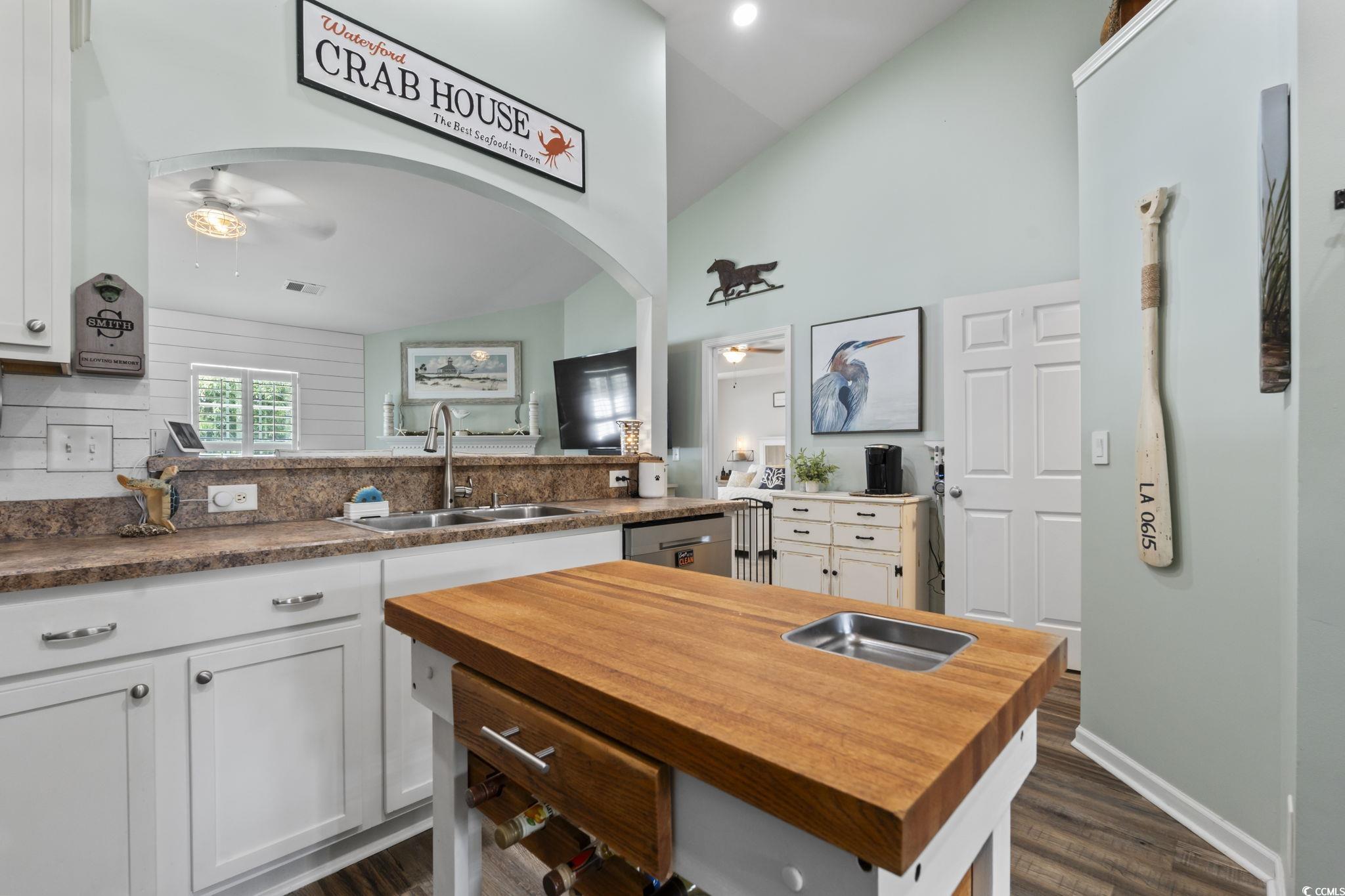 1604 Langley Drive Longs, SC 29568 - Photo 24 of 37 Kitchen featuring butcher block countertops, white cabinetry, a ceiling fan, and high vaulted ceiling