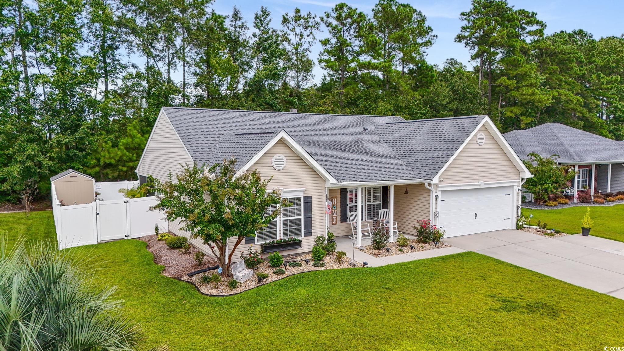 1604 Langley Drive Longs, SC 29568 - Photo 3 of 37 View of front of house with covered porch, roof with shingles, a gate, concrete driveway, and an attached garage