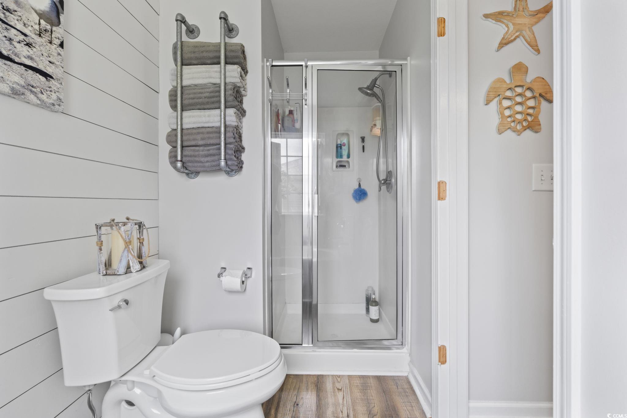 1604 Langley Drive Longs, SC 29568 - Photo 31 of 37 Full bath featuring wood finished floors, a shower stall, and wooden walls