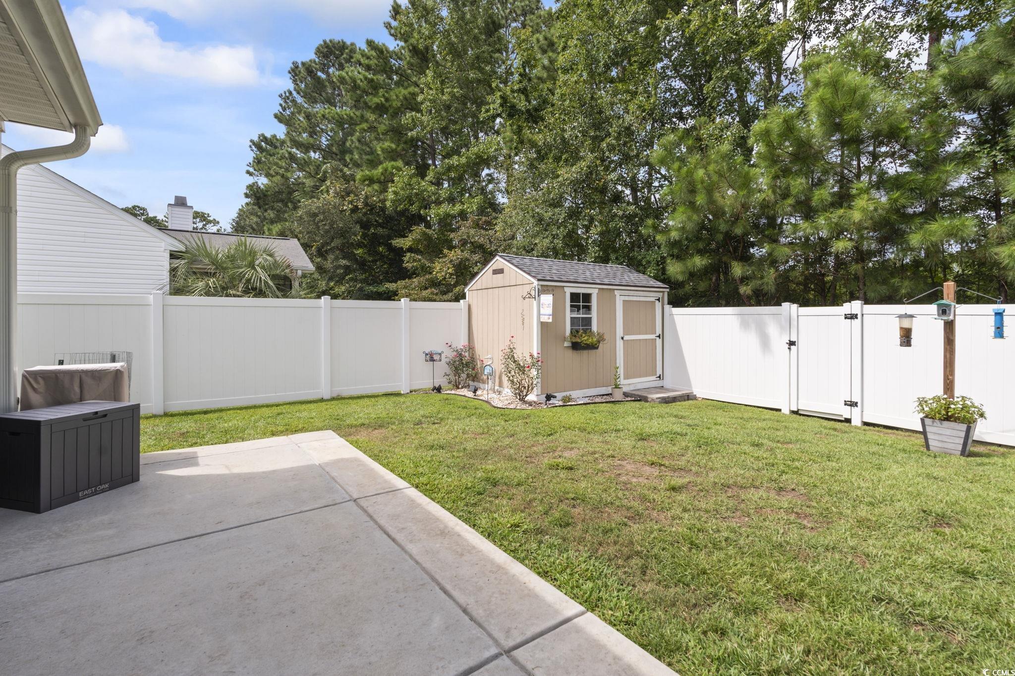 1604 Langley Drive Longs, SC 29568 - Photo 36 of 37 Rear view of property featuring a chimney, a shingled roof, a sunroom, and a patio
