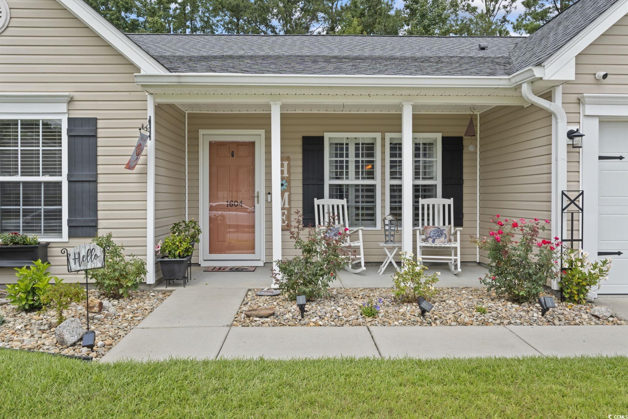 1604 Langley Drive Longs, SC 29568 - Photo 7 of 37 Property entrance featuring covered porch, a shingled roof, and a garage