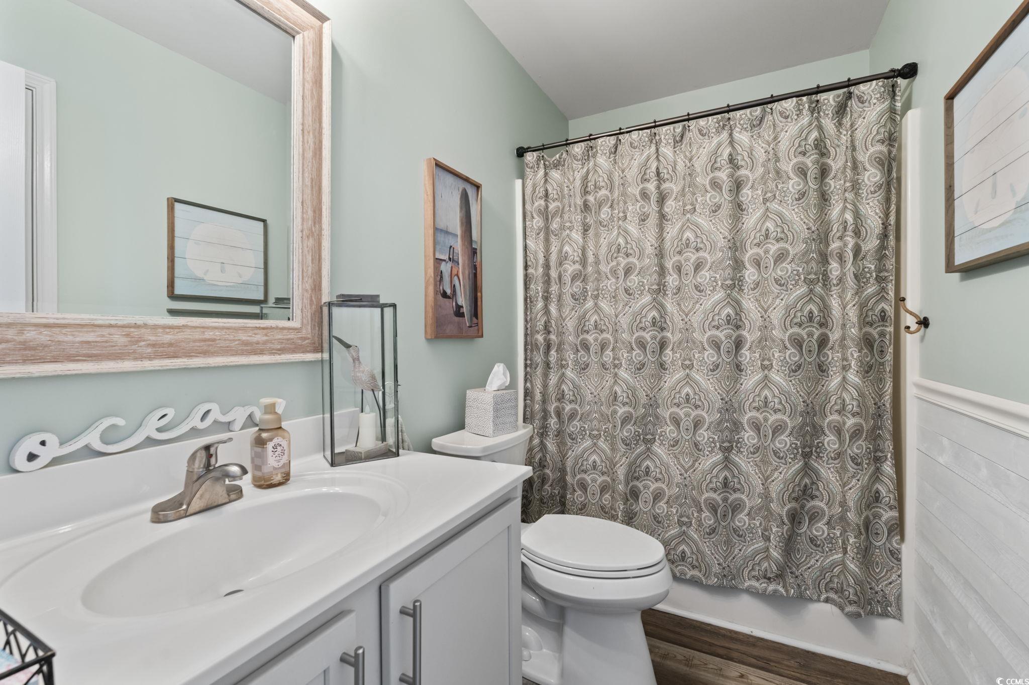 1604 Langley Drive Longs, SC 29568 - Photo 10 of 37 Full bathroom featuring vanity, wood finished floors, and curtained shower
