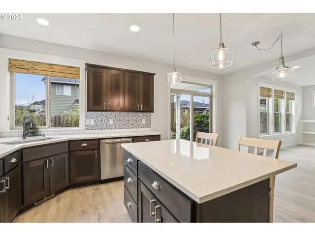 a kitchen with a sink a center island and cabinets