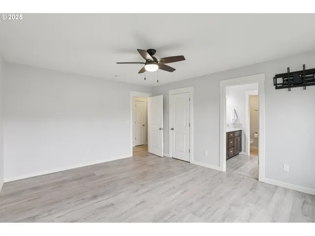 a view of an empty room and wooden floor
