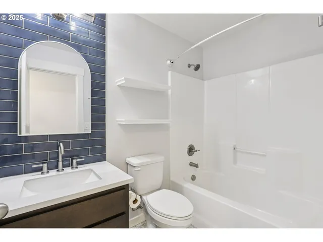 a bathroom with a sink toilet vanity and shower