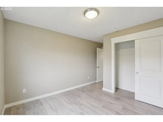 a view of an empty room and wooden floor