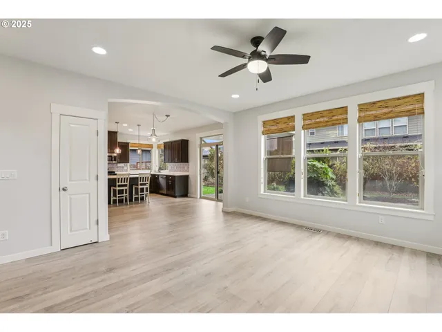 a view of a livingroom with furniture wooden floor and window