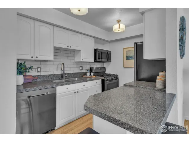 a kitchen with kitchen island sink stove and cabinets