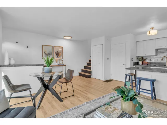 a living room with furniture and a dining table
