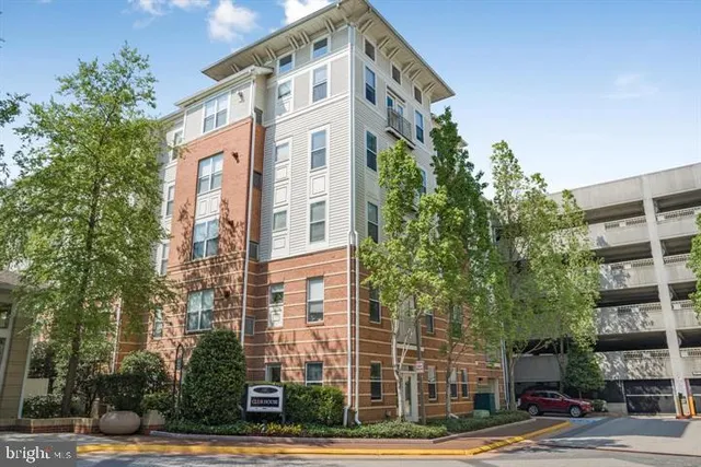 a front view of a multi story building with a yard