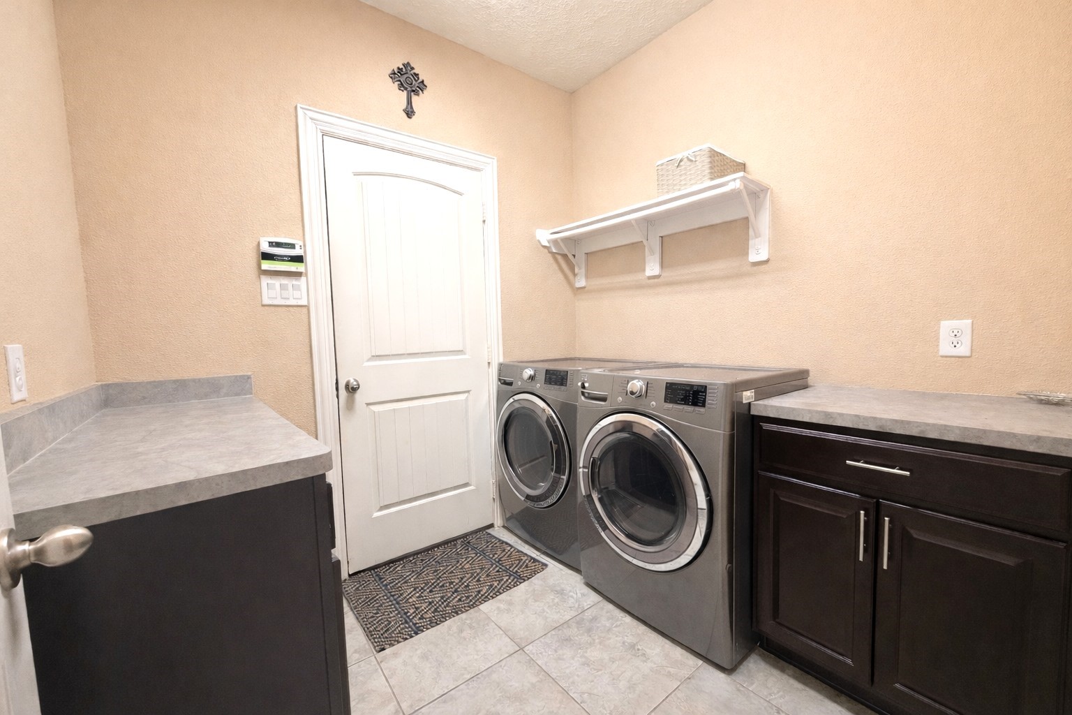 111 Meadow Ridge Way Clute, TX 77531 - Photo 17 of 17 Efficient laundry room with ample counter space for convenience.