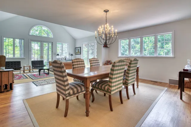 a view of a dining room with furniture window and wooden floor