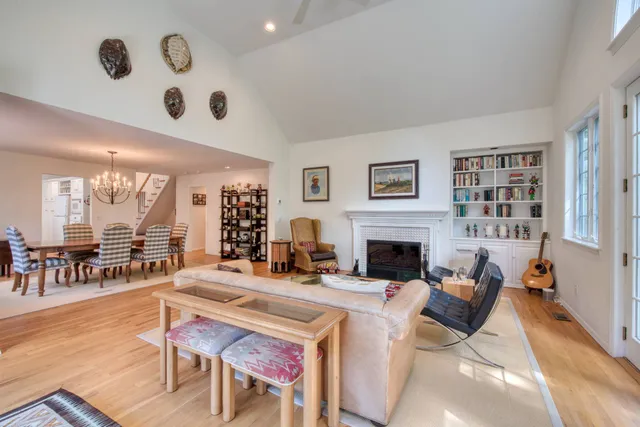 a living room with furniture a fireplace and a large window