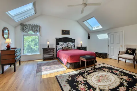 a bedroom with a bed a table and chair