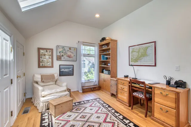 a room with furniture a rug and a window