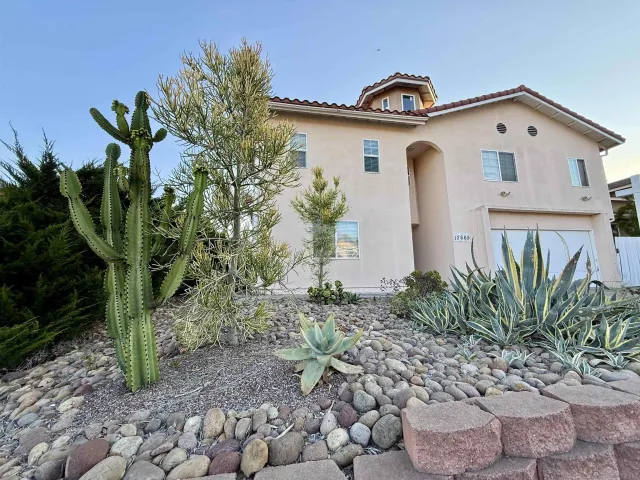 a view of a front of a house with a yard