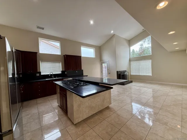 a kitchen with stainless steel appliances granite countertop a stove a sink and a refrigerator