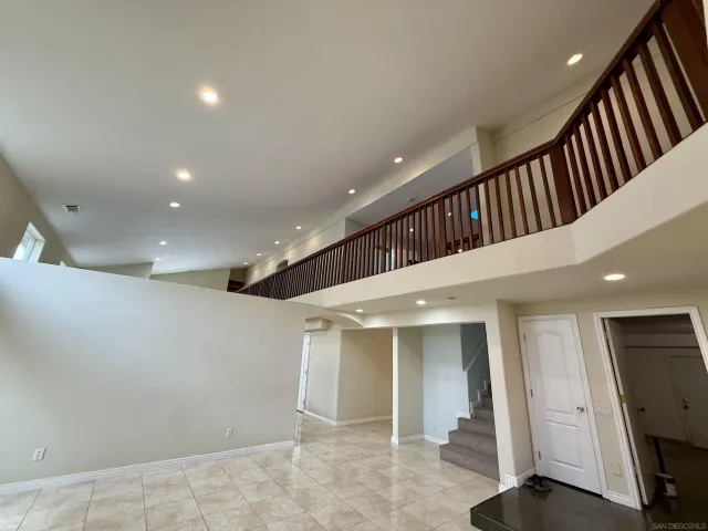 a view of a room that has a window and a wooden floor