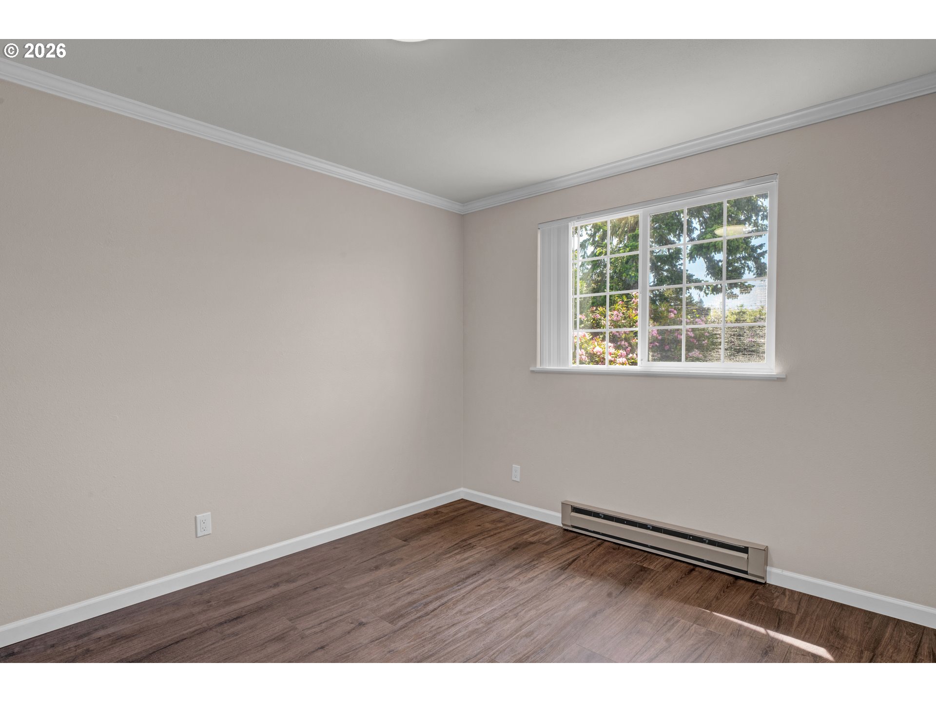 1142 9th Street Florence, OR 97439 - Photo 27 of 41 an empty room with wooden floor and windows