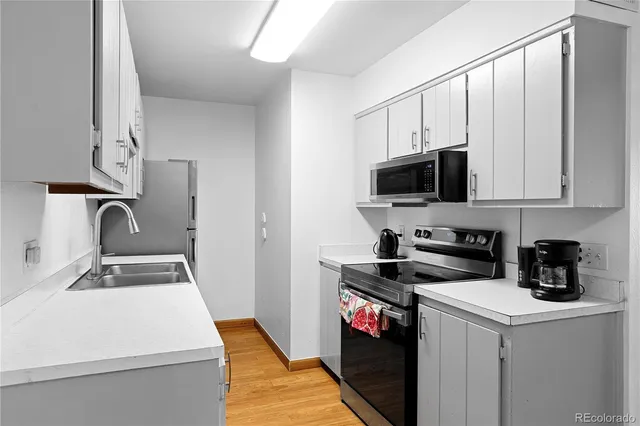 a kitchen that has a sink and a stove in it
