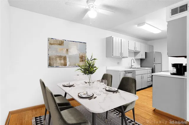 a kitchen with stainless steel appliances kitchen island a table and chairs in it