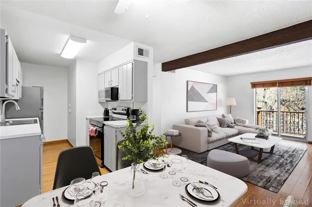 a living room with furniture potted plant and a window
