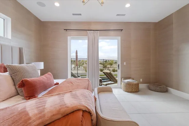 a bedroom with a large bed and a large window