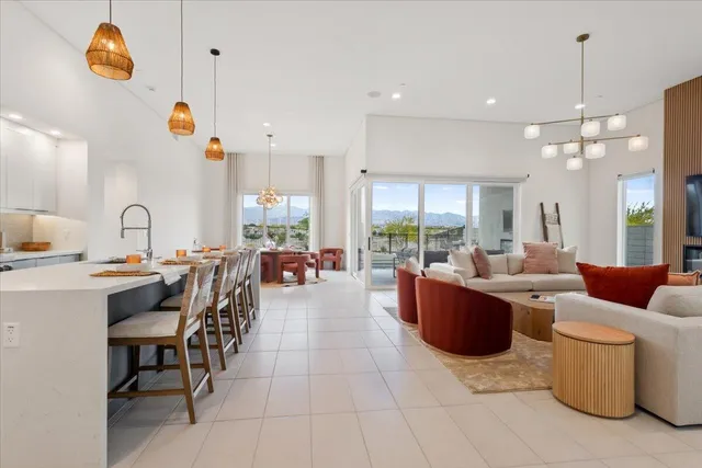 a large living room with stainless steel appliances kitchen island granite countertop a large counter top and couches