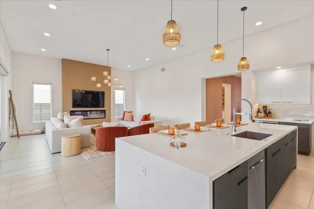 a kitchen with a sink a counter and chairs
