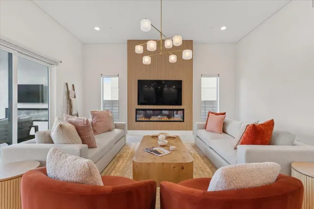 a living room with furniture a flat screen tv and a fireplace