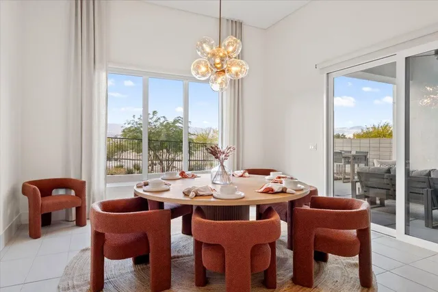 a dining room with furniture a large window and chairs