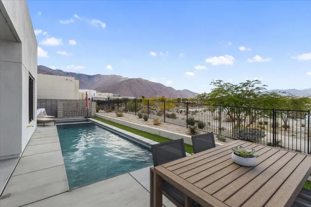 a view of a balcony with mountain view and wooden floor