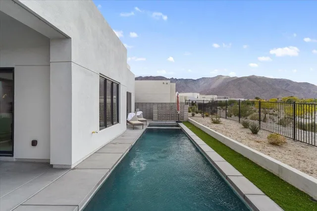 a view of a house with a yard and sitting area
