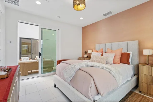 a bed room with a bed and a potted plant