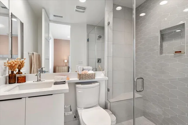 a bathroom with a toilet sink and shower