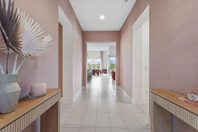 a view of a hallway and a dining room with furniture