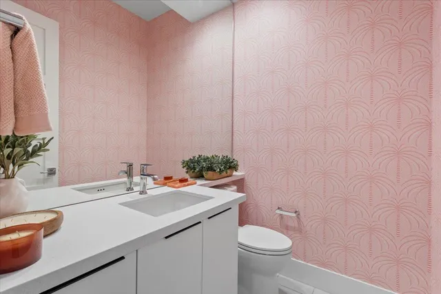 a bathroom with a sink a toilet and mirror