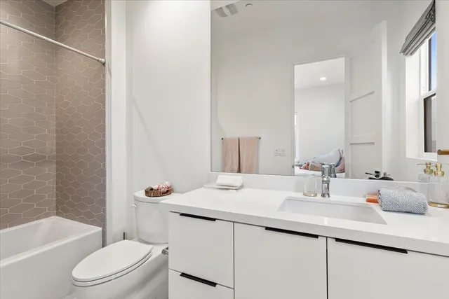 a bathroom with a sink toilet tub and shower