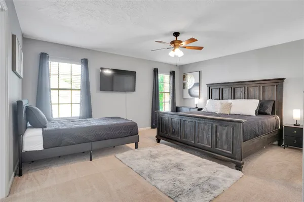 a bedroom with a bed and a chandelier