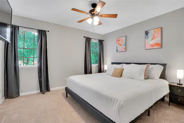 a bedroom with a large bed and a chandelier