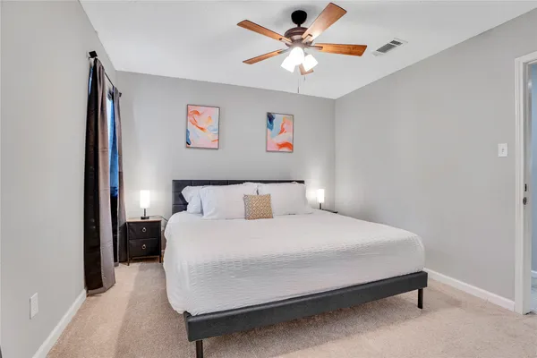 a bedroom with a bed and a chandelier