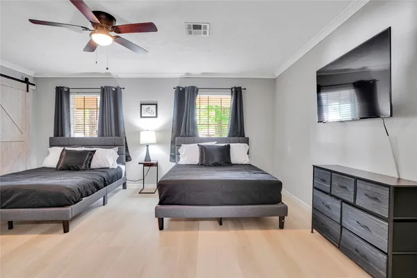 a bedroom with a bed and a chandelier