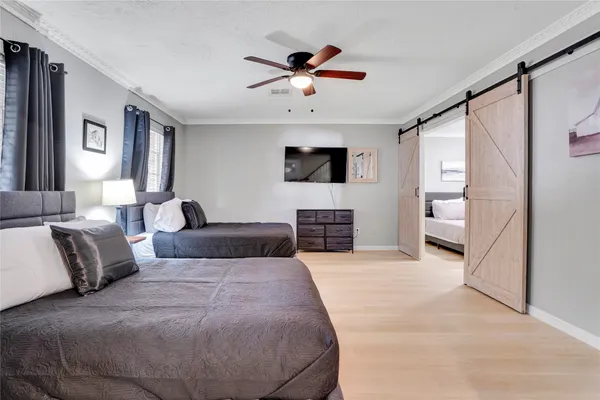 a spacious bedroom with a large bed and a flat screen tv